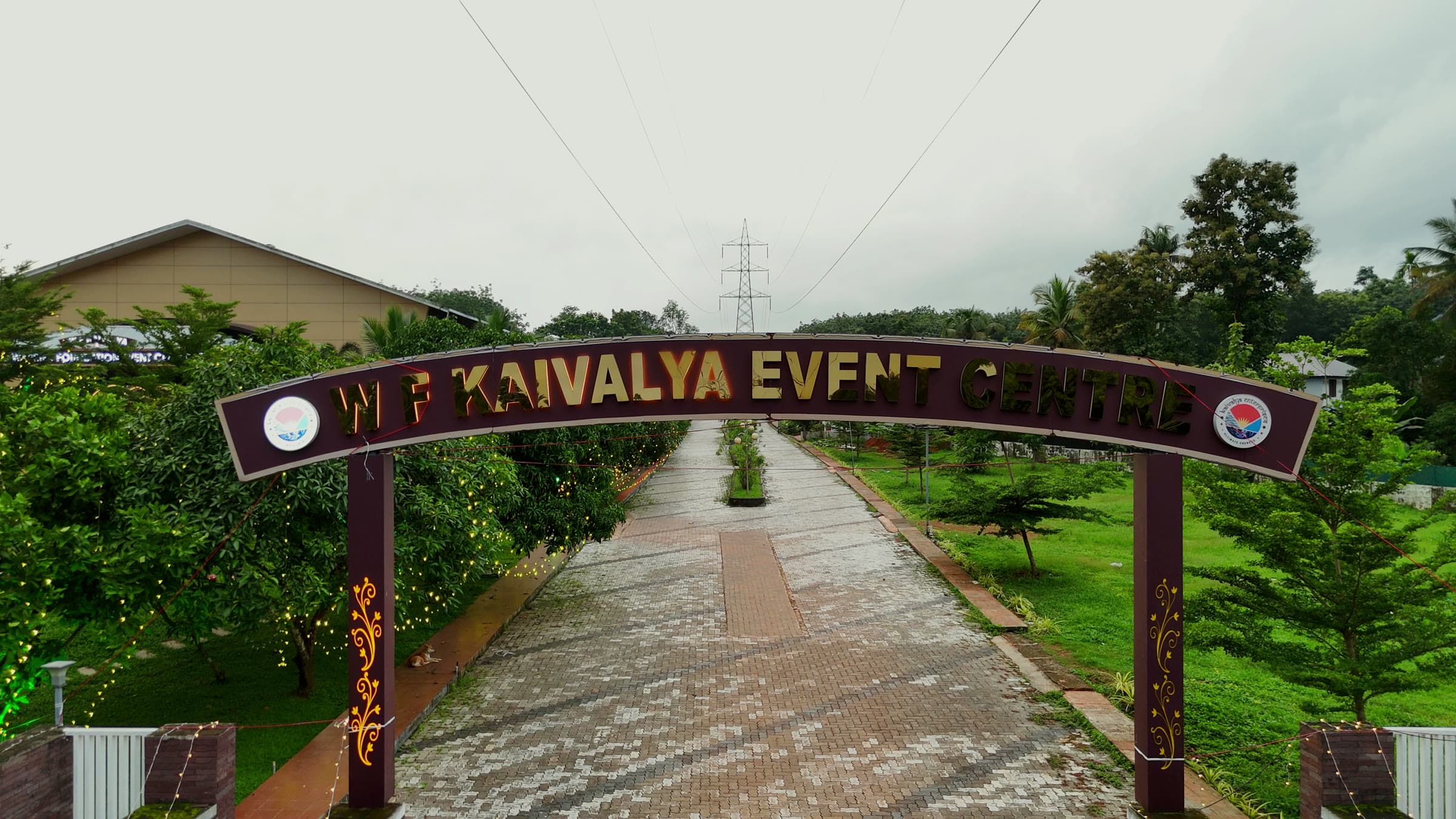 The W F Kaivalya gate arch spanning the tree-lined approach