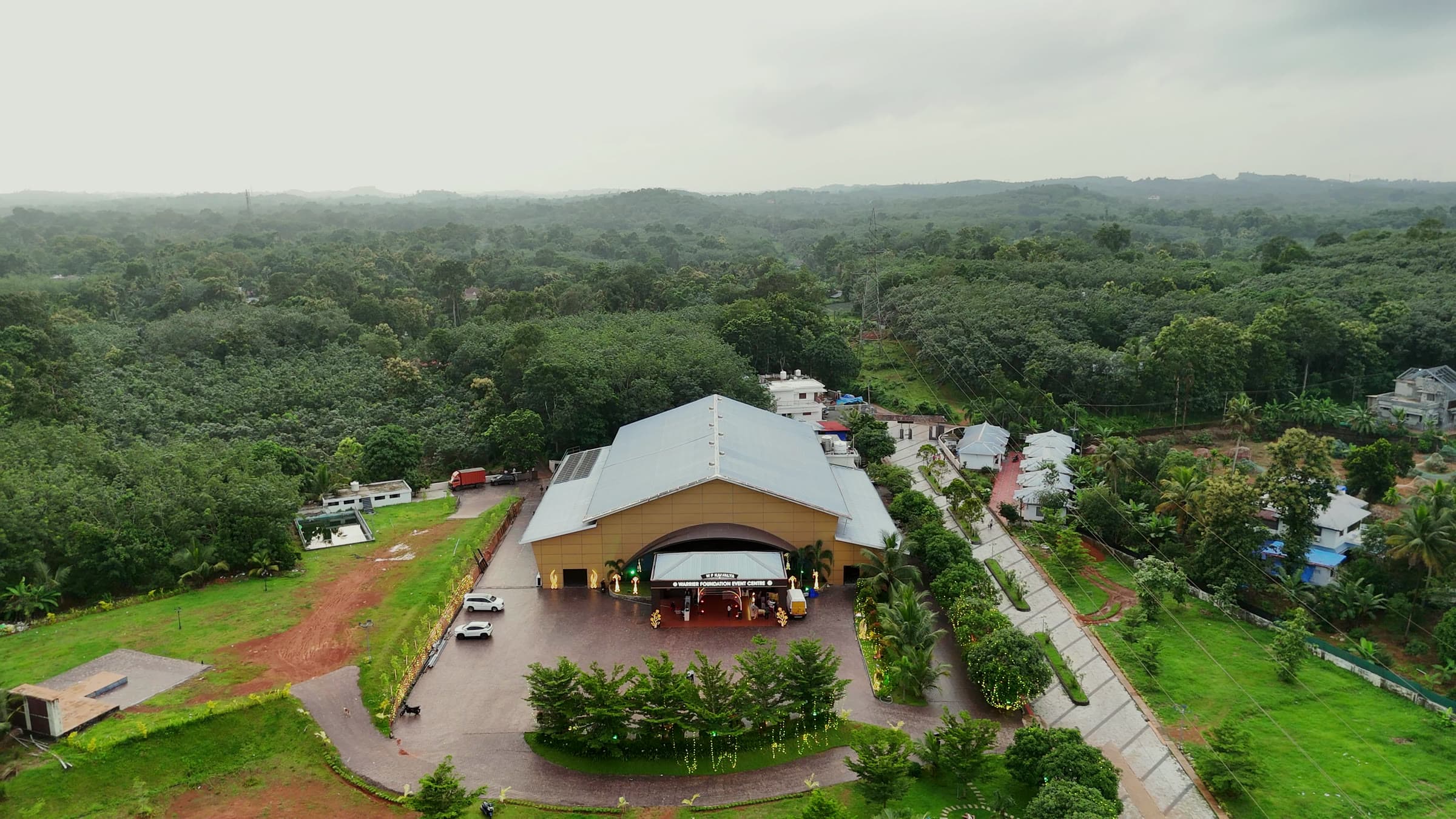 Wide aerial of the estate, its drive and lawns in their green setting