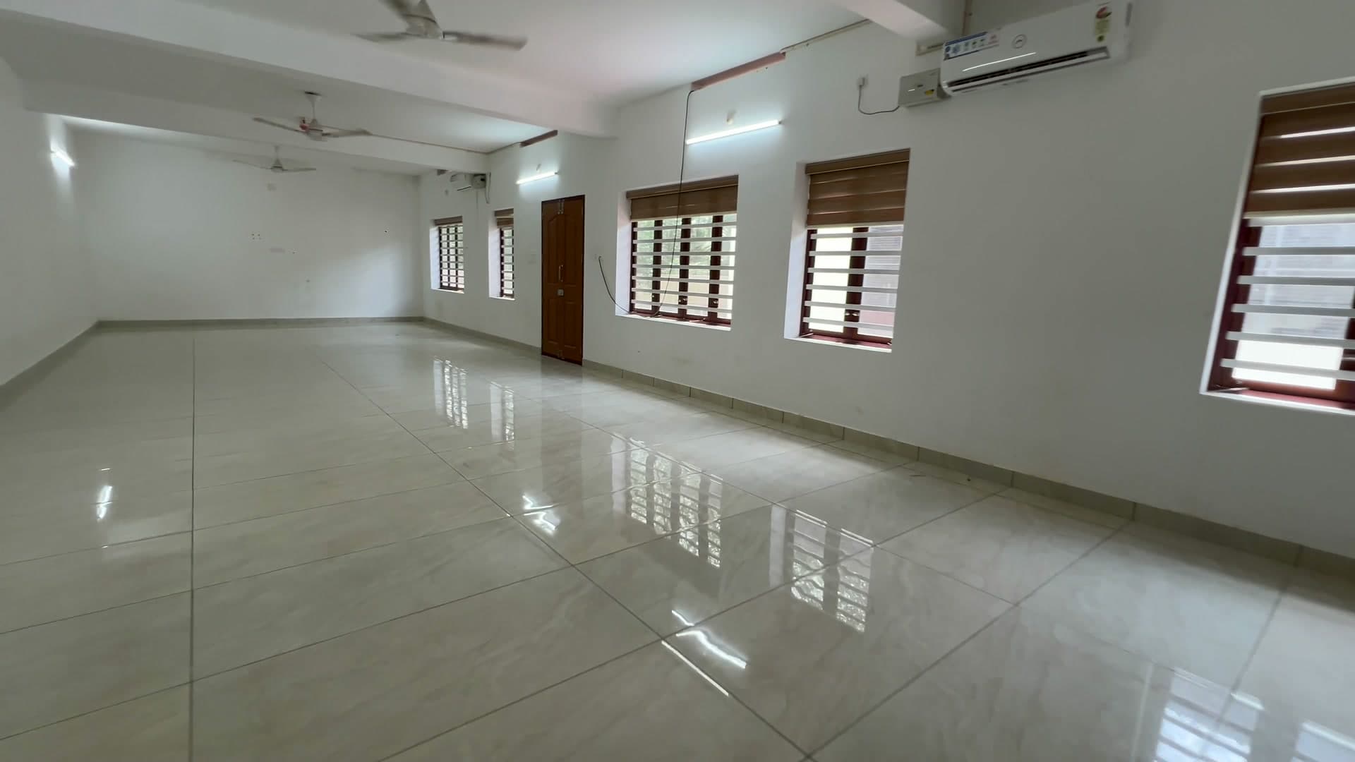 Crystal Conference Hall — the bright, fully air-conditioned room with windows and a tiled floor