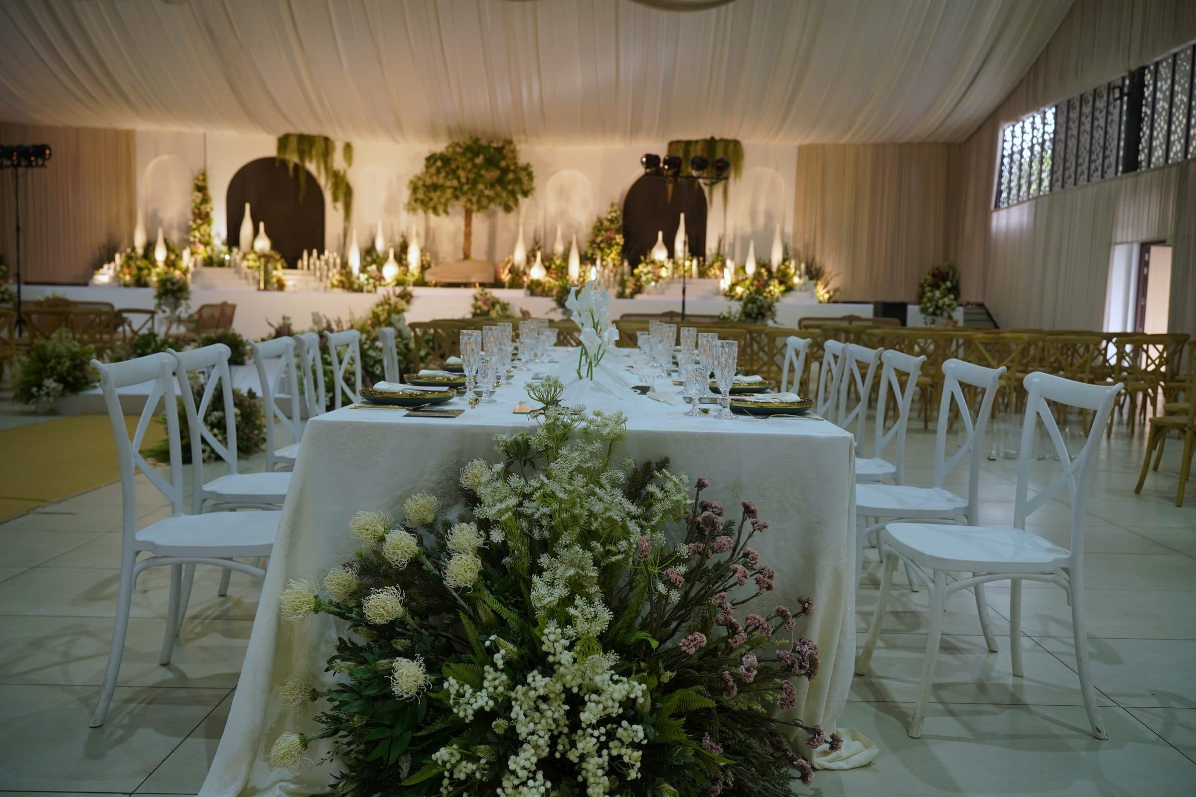 The head table with a full floral arrangement