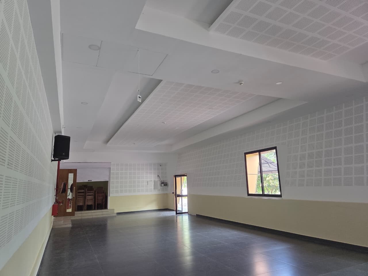 An angled view across the hall toward the windows